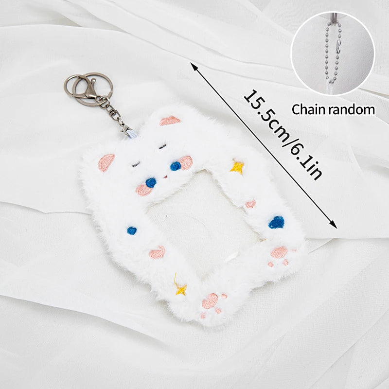 White plush photo card holder with a cat face design and a chain for decoration
