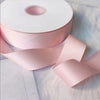 Roll of matte finish pink satin ribbon for crafts, wrapping, and decor