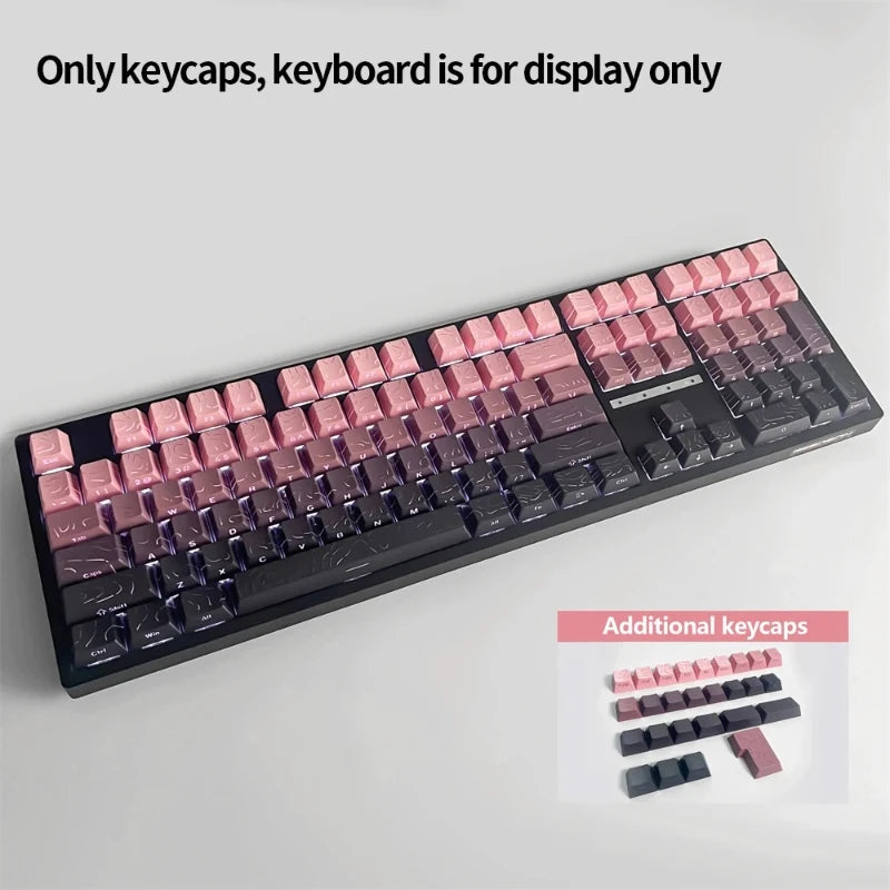 A close-up view of a black mechanical keyboard featuring pink and purple PBT keycaps, with additional keycaps displayed below