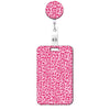 A pink leopard print retractable badge holder with a circular top.