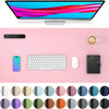 A pink desk mat featuring a laptop, keyboard, mouse, and a monitor, surrounded by various colored circles.