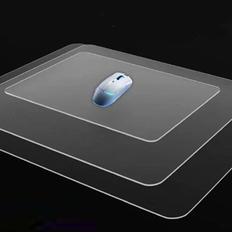 A white wireless mouse resting on a clear frosted glass anti-slip mouse mat.