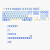 A set of dark blue PBT keycaps with cherry profile for mechanical keyboards, arranged in various layouts.