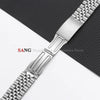 A close-up view of a polished stainless steel watch band with a textured surface and folding clasp.
