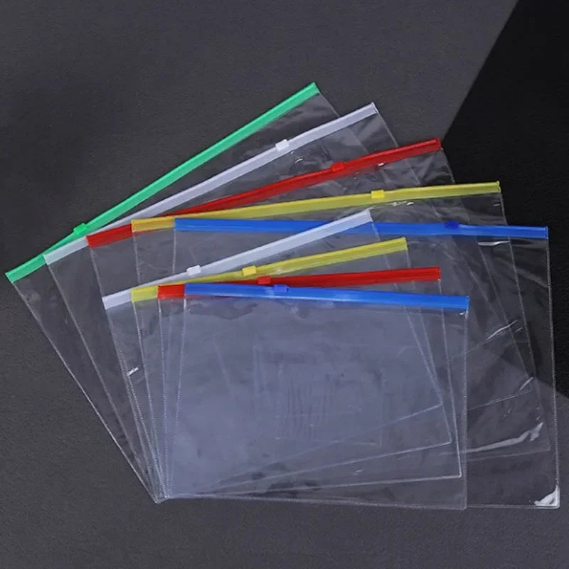 A collection of nine transparent plastic document file organizer bags filled with colored plastic pens and rulers.