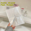 A clear A5 refillable photo sleeve with pink accents and a perfume bottle displayed on a white shelf.