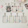 Collection de porte-photos en acrylique transparent avec différents éléments décoratifs et pendentifs en forme d'étoile.