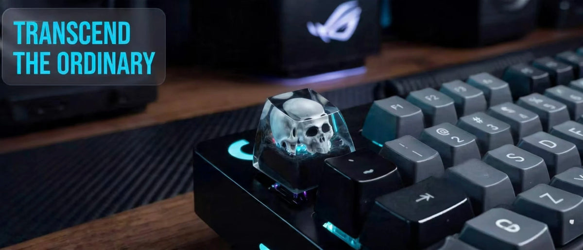 A close-up of a black mechanical keyboard featuring a monochrome skull resin keycap.