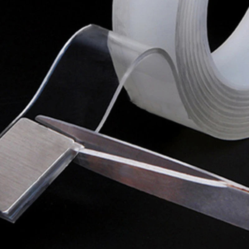 A close-up of extra strong double-sided nano tape being applied to a surface.