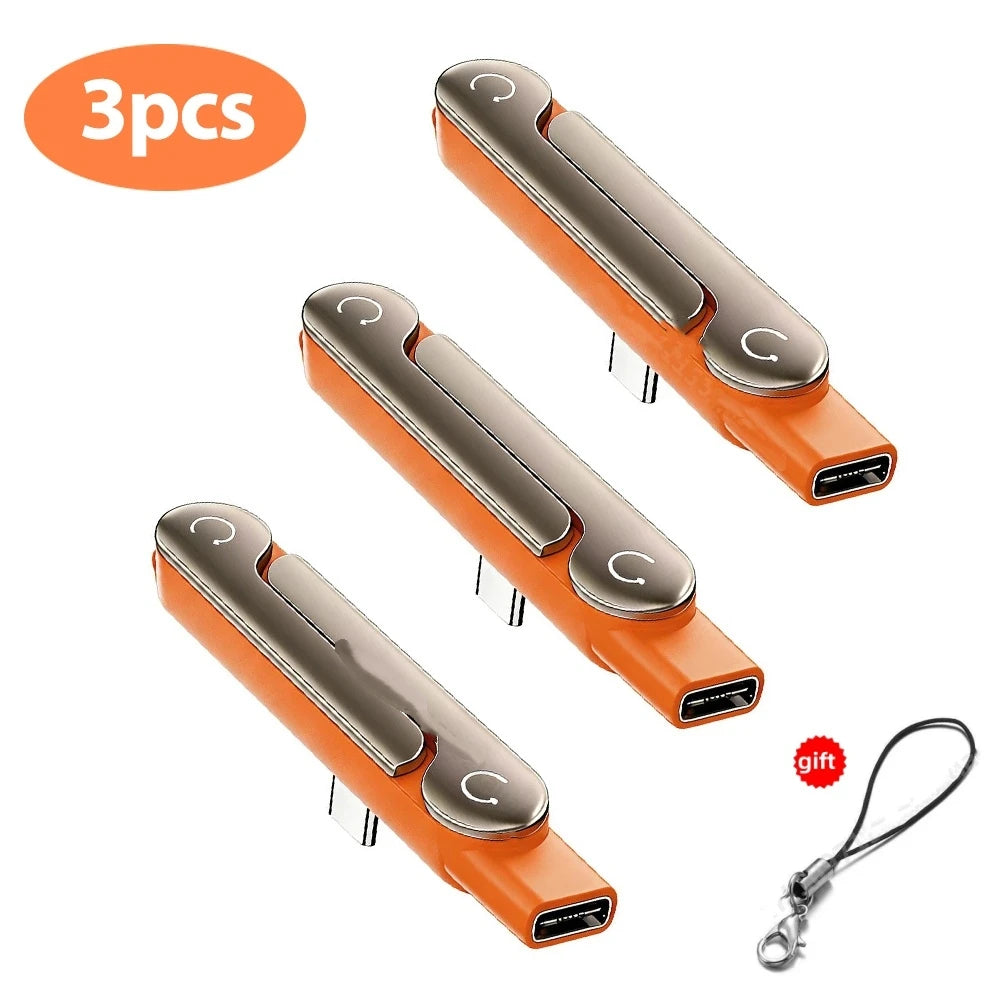 Three orange USB-C adapters with foldable stands for fast charging and data sync