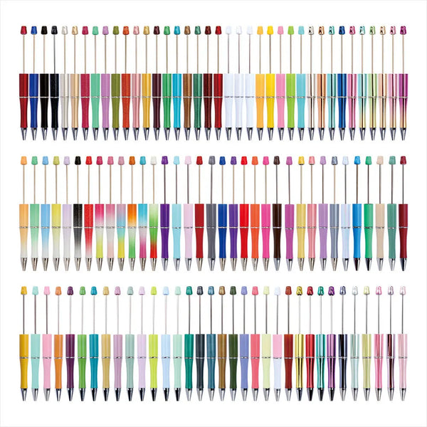 A large collection of beadable pens in various colors and finishes arranged in rows.