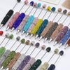 A collection of 20 rhinestone beaded pen accessories in various colors and finishes.