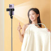 A woman wearing a white top is positioned next to an ultra-long selfie stick with a built-in light, demonstrating its use.