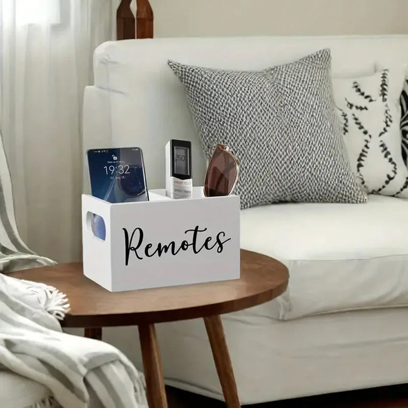 A white wooden storage box with dividers is placed on a bedside table next to a white sofa.