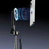 A close-up of a black magnetic selfie stick with a phone attached, demonstrating instant magnetic attachment.