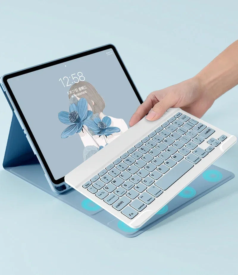 A hand is typing on a white magnetic keyboard case for an iPad Pro next to the tablet.