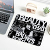 A black and white design featuring the text BEAUTY THAT KAWAKIMI HAUNTS TOMIE on a mouse pad.