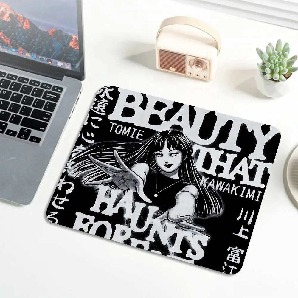 A black and white design featuring the text BEAUTY THAT KAWAKIMI HAUNTS TOMIE on a mouse pad.