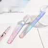 A pink and blue gradient measuring tool with a curved edge is shown next to a ruler and a pencil on a white surface.
