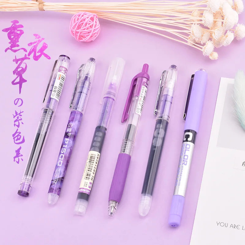 A set of purple and pink precision rollerball gel pens arranged on a light purple background with dried flowers.