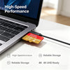 A close-up of a laptop and a SanDian Extreme high-speed memory card being used for storage.