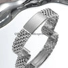 A close-up view of a polished stainless steel watch band with a folding clasp.