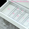 A white acrylic drawer organizer set with seven compartments labeled XL, S, M, L, and others.