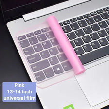 A pink silicone keyboard cover for a laptop is shown with a keyboard placed on the white laptop surface.