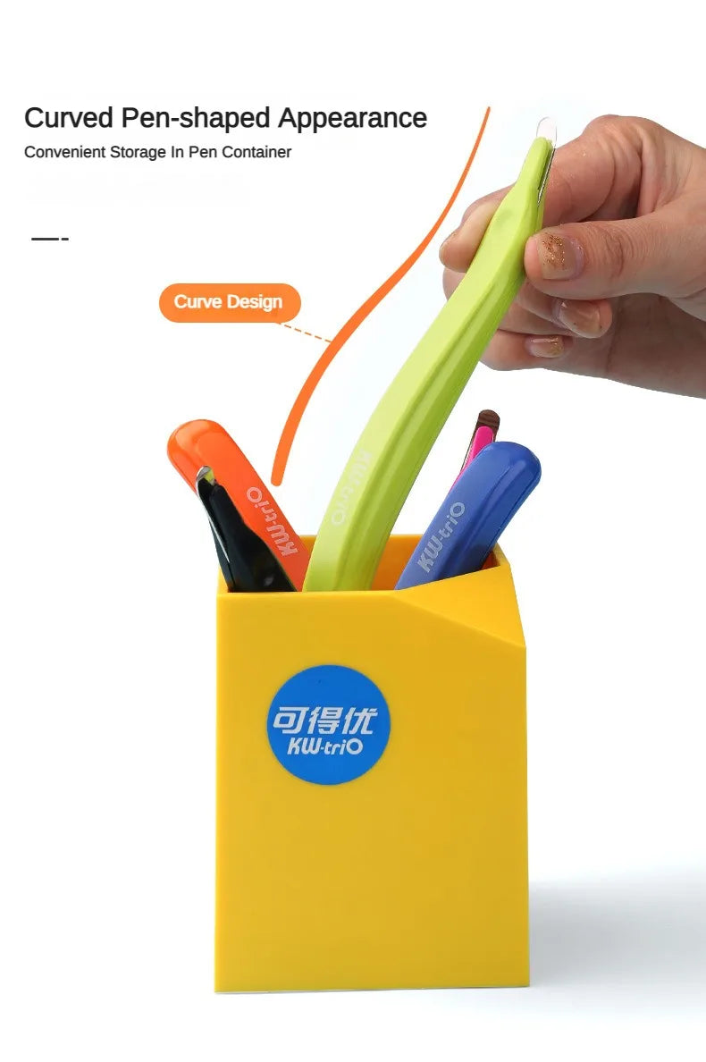 A yellow container holds various colored pen-shaped tools, including a lime green one, demonstrating a curved design.