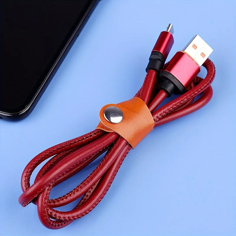 A bundle of red faux leather data cables with USB connectors and a leather wrap.