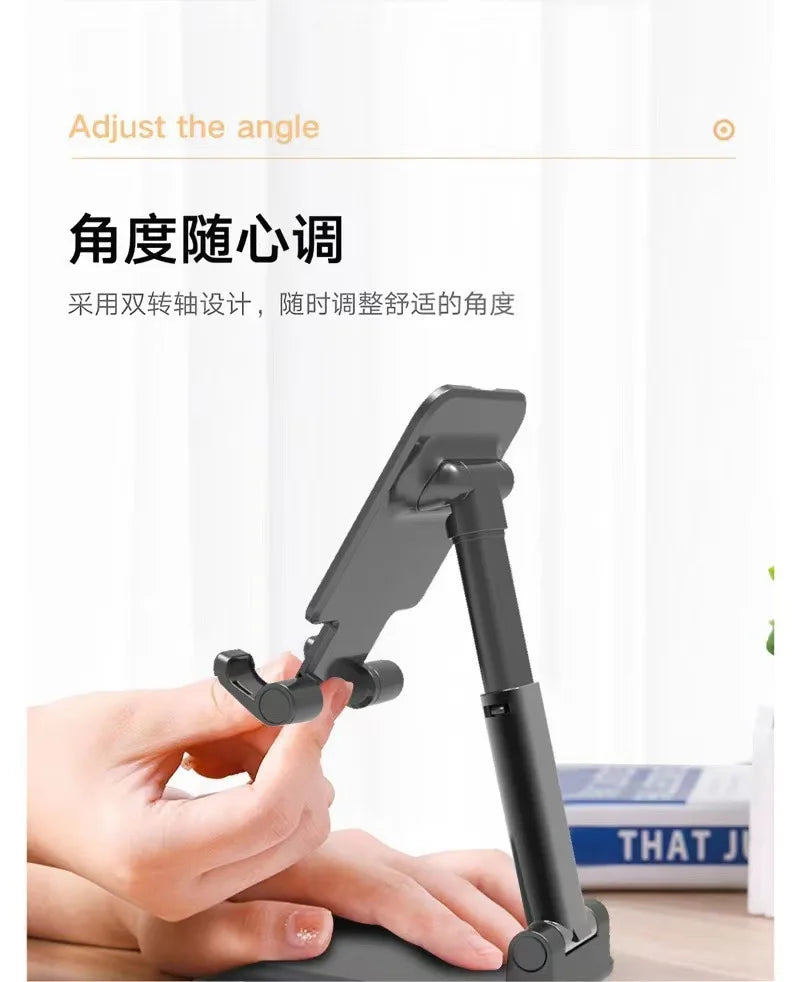 A hand adjusts the angle of a black foldable desktop phone stand used for live streaming.