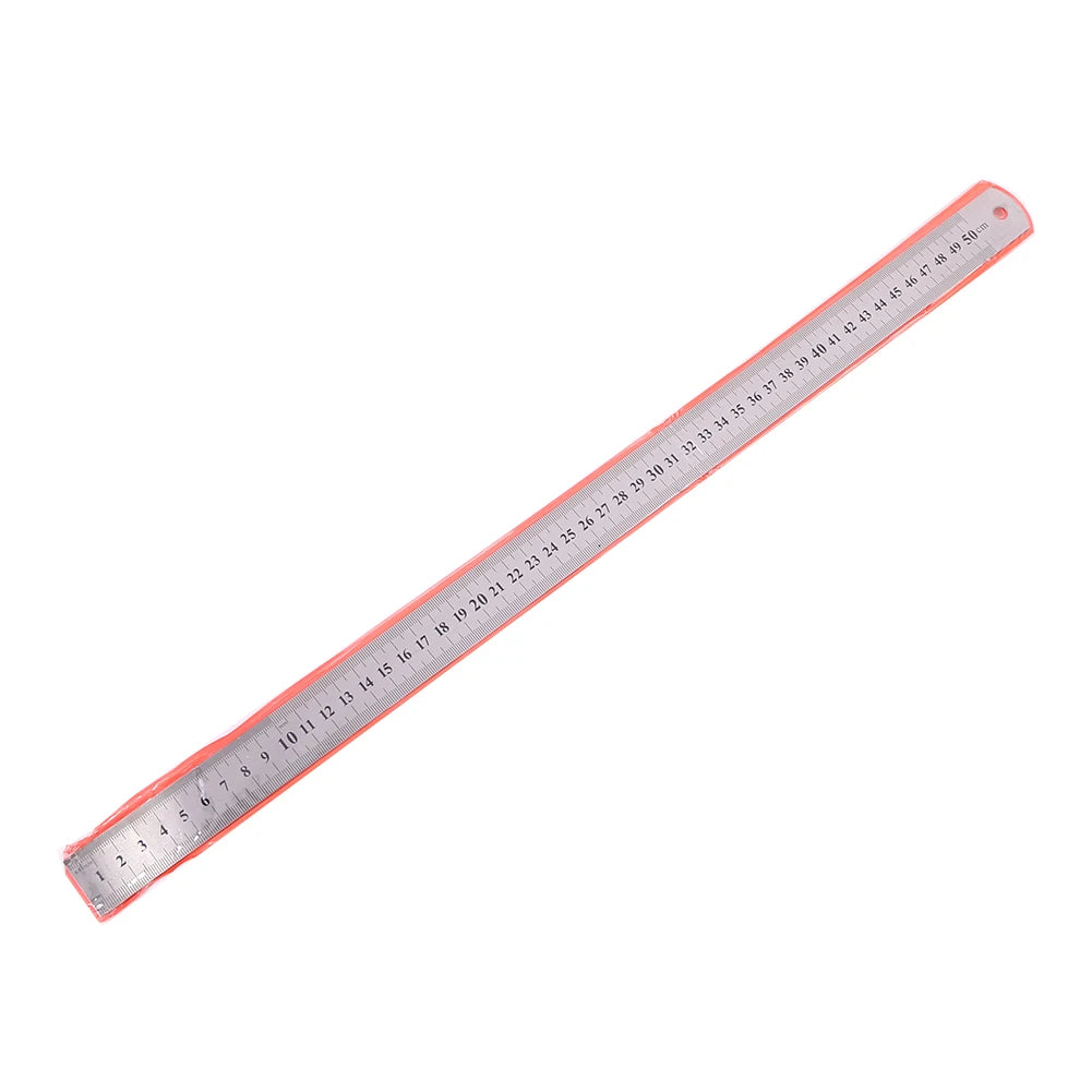 A long, thin stainless steel measuring ruler with millimeter markings and a scale visible.