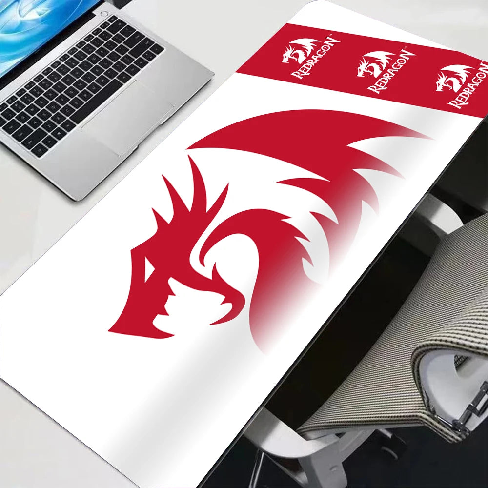 A red and white anime gaming mouse pad with a dragon design is shown next to a laptop.