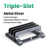 A metal silver triple-slot vertical laptop stand with an adjustable width and full aluminum alloy construction.