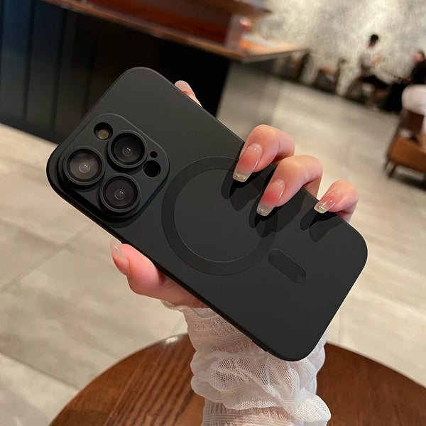 A hand holds a black MagSafe compatible iPhone case with a circular cutout design.