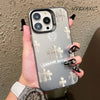 A hand holds a holographic gradient phone case for an iPhone featuring cross designs.