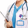 A person wearing a white lab coat and blue scrubs holds a diagram badge reel with a stethoscope.