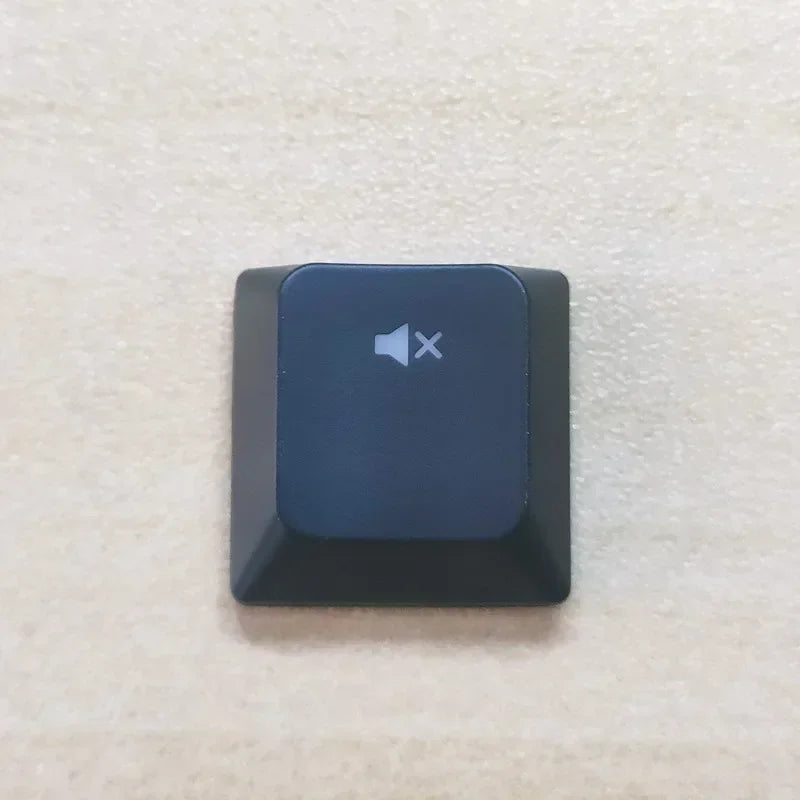 A dark blue replacement keycap for a keyboard, featuring a speaker icon and an X symbol.