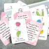 A collection of pink and white affirmation cards featuring inspirational quotes and simple line drawings on a silver laptop.