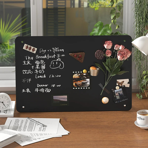 A large magnetic planning board featuring various food items and text written in Chinese characters.
