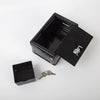 A black compact home safe box with an open lid showing a combo lock and keys.