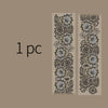 Two vertical strips of decorative silver stamping lace tape featuring intricate floral patterns on a beige background.