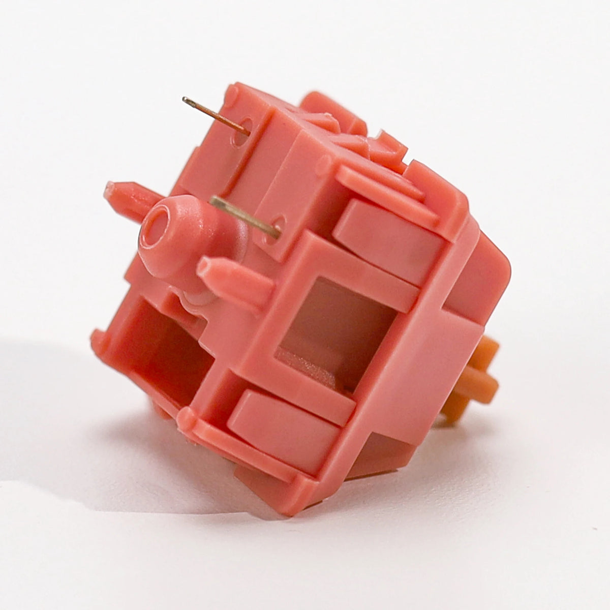 A close-up view of a pink rosewood linear mechanical keyboard switch housing.