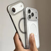 A hand holds a slim magnetic phone case for an iPhone, showing the back and camera module.