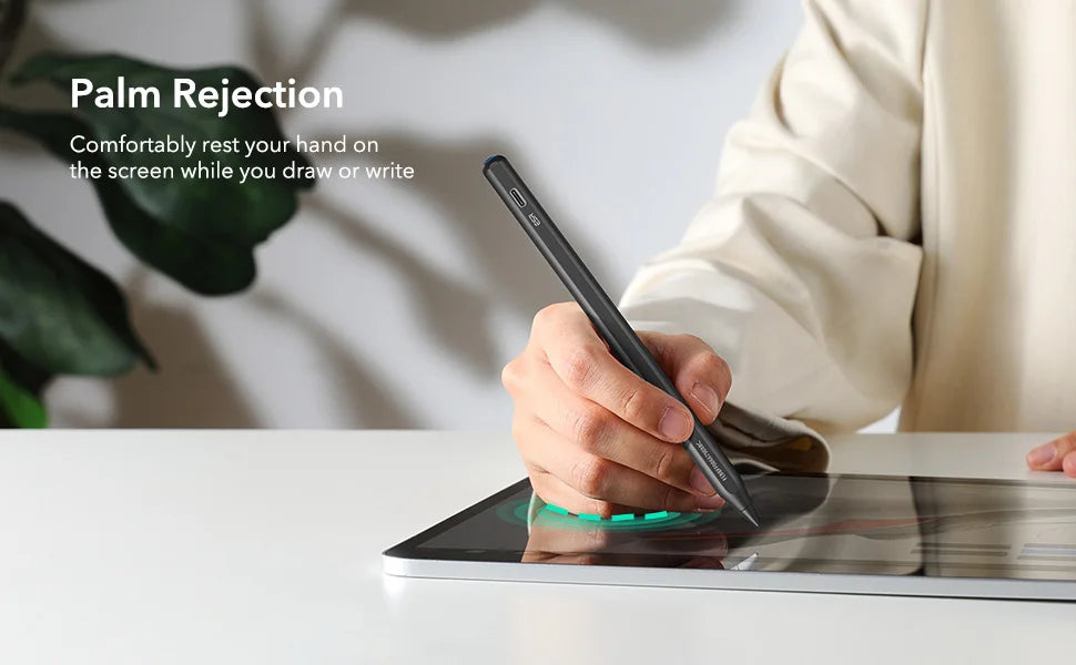 A hand holds a stylus pen on an iPad screen, demonstrating palm rejection technology.