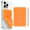 A silicone suction cup phone holder in orange, shown with an attached grip and a flat suction pad.