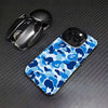 A blue and white camouflage patterned phone case is shown next to a black iPhone case.