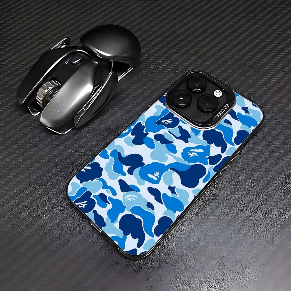 A blue and white camouflage patterned phone case is shown next to a black iPhone case.