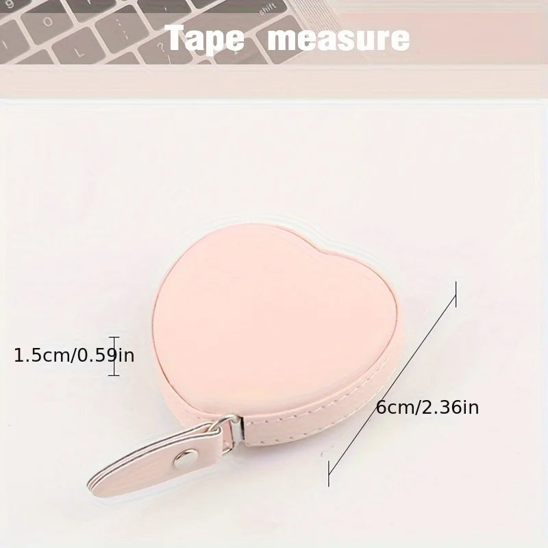 A pink PU leather heart-shaped measuring tape is shown with its dimensions marked.