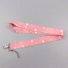 Pink heart-shaped lanyard strap with a repeating pattern for badges and keys